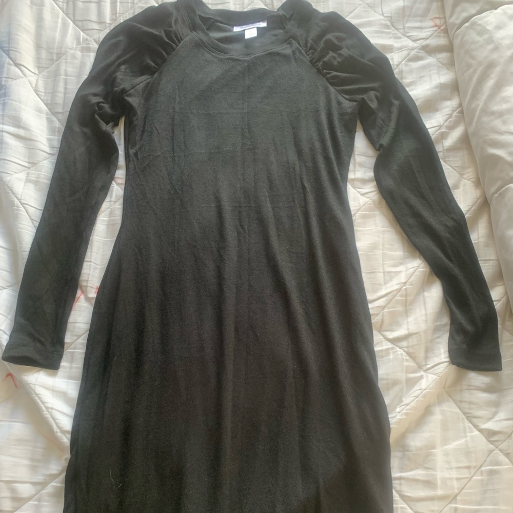 Long black dress with puff sleeves.